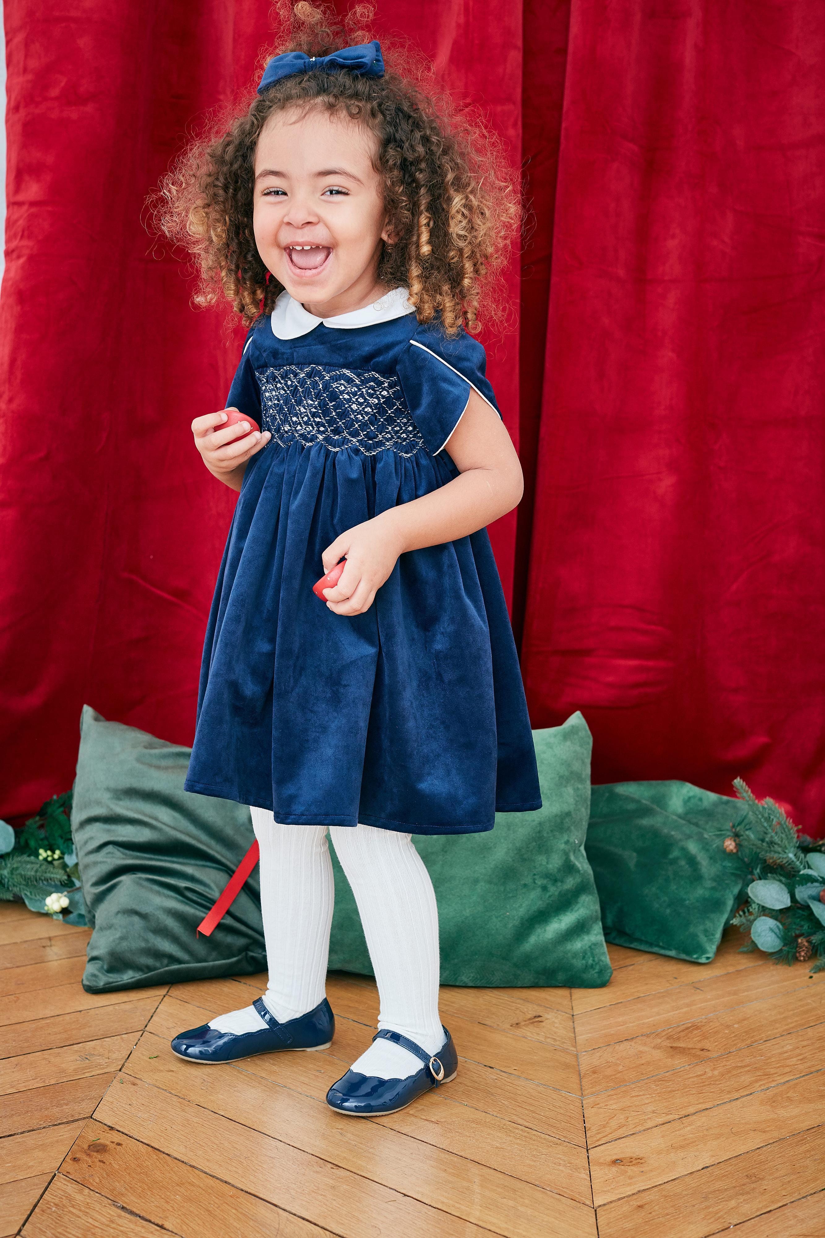 Clémence, Dress with short petal sleeves, peter pan collar, smocked waist, zipped back opening, in Navy velvet