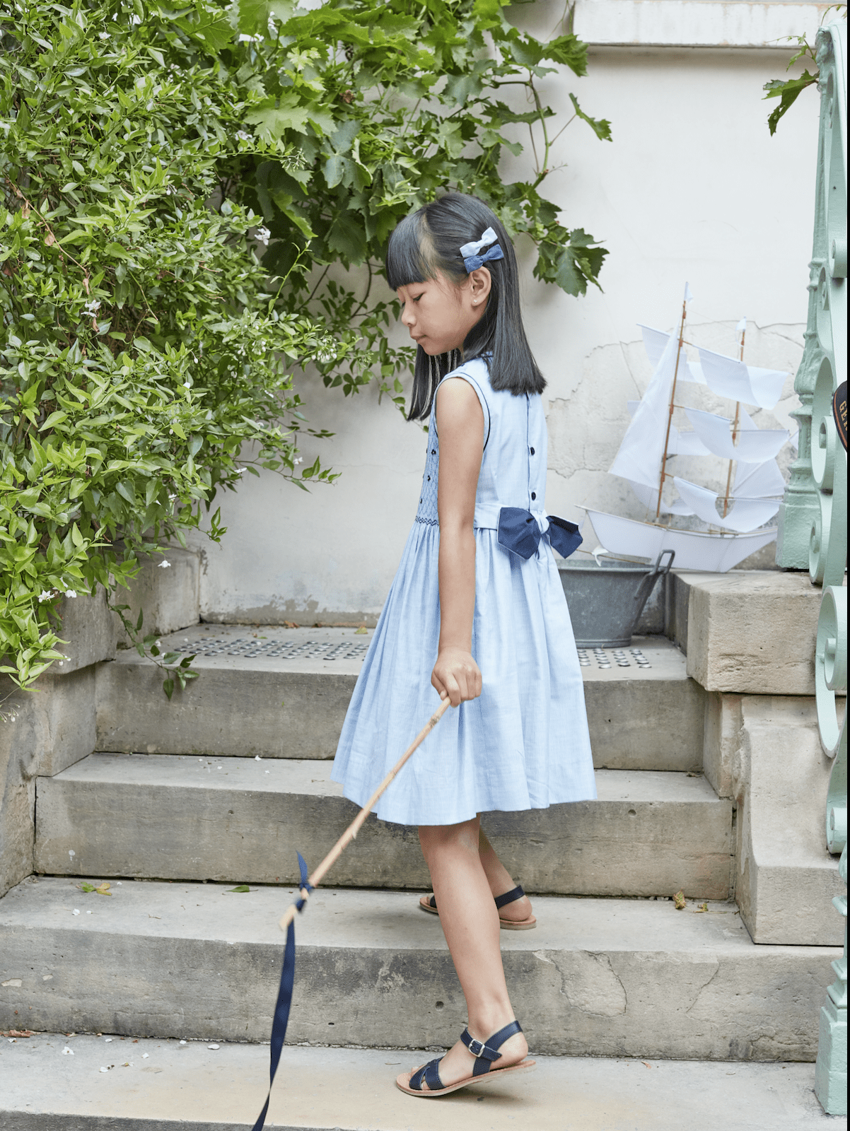 Emma, sleeveless, dress with fully smocked top, inThin blue and whites stripes