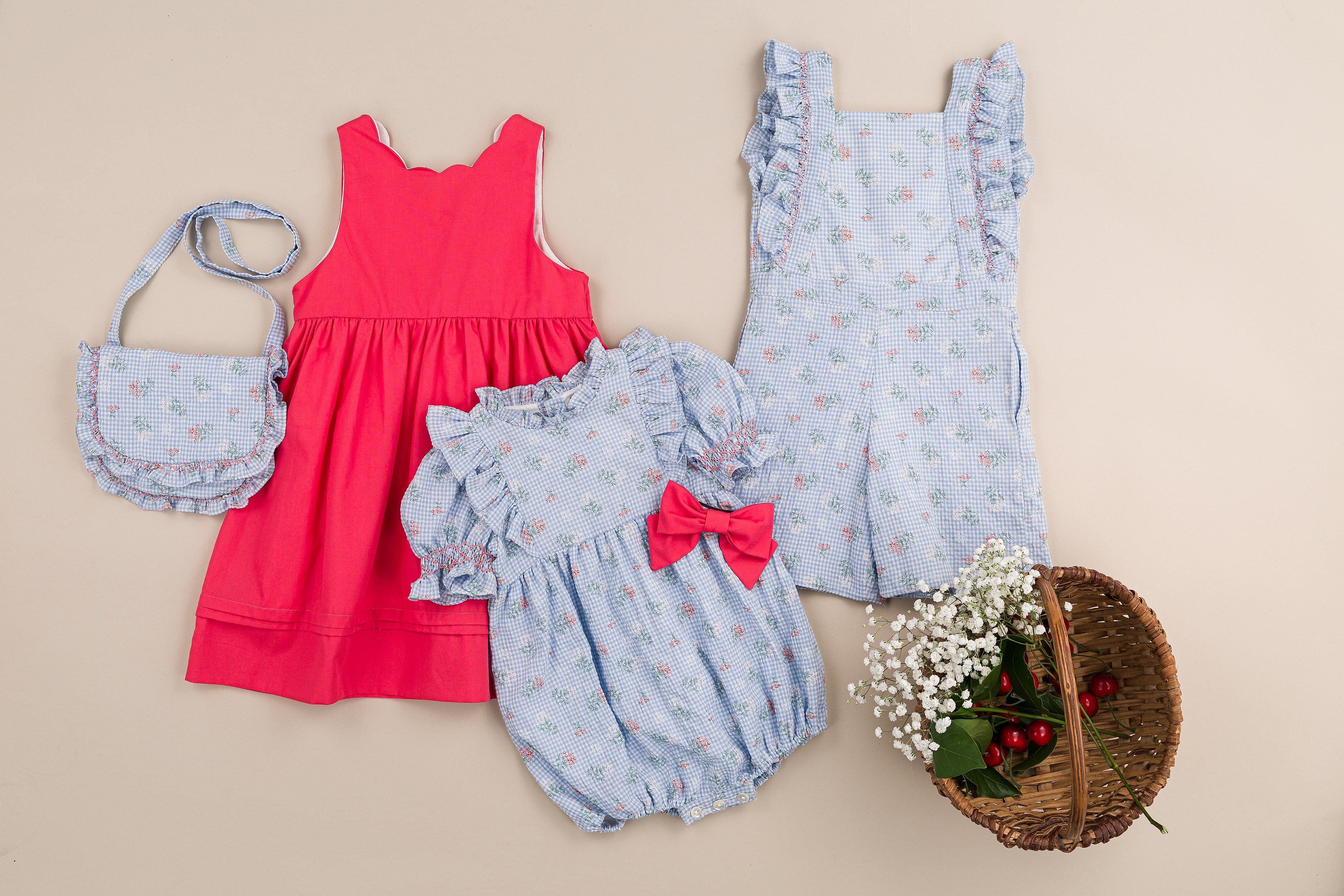 Laéline,  girl dungarees with ruffled smocked straps, in Blue seersucker gingham with bouquet print